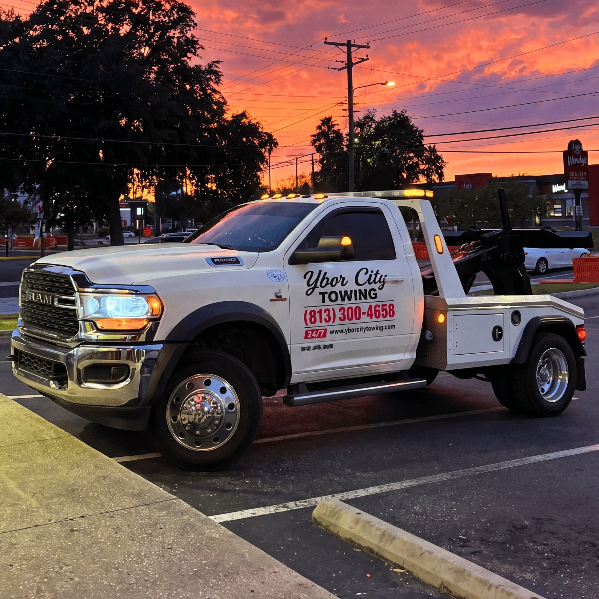 Ybor City Towing RAM flatbed truck at sunset in Tampa, FL — 24/7 tow service